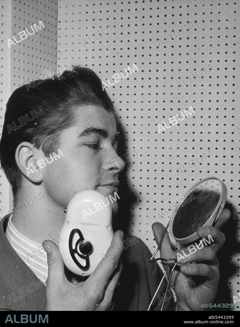 Clockwork Shaver - A New Dry-shave Razor, worked by a spring which is wound up just like a clock, is becoming very popular on the continent. After being wound up the Razor works for four minutes and can be rewound during a shave if necessary. A built-in centrifugal regulator ensures constant revolutions..and the razor is completely noiseless. May 09, 1955. (Photo by Paul Popper Ltd.).