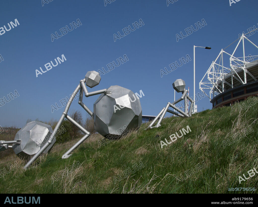 SIMON INGLIS. Stadium of Light, Millennium Way, Monkwearmouth, Sunderland, 2010. The sculpture "Men of Steel" by Graeme Hopper, on the grassy slope between the River Wear and the Stadium of Light, Sunderland. The sculpture was installed in 2001. It is one of several pieces of public art located around the stadium complex.