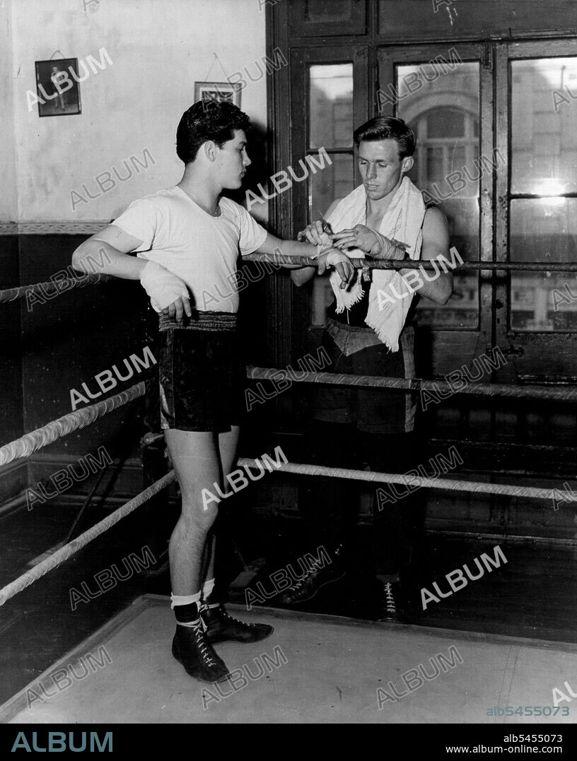 Charlie Dunn who meets Ray Fitton at the Stadium on Monday night in an earlier picture with worlds Champion Jimmy Carruthers. June 15, 1953. (Photo by Phil Ward Studios).