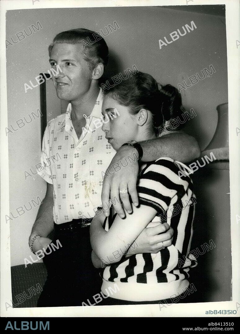 May 23, 1958 - 22 Year-Old American Rock 'N Roll Singer Arrives Here With His 15 Year Old Wife; Jerry Lee Lewis, the American rock ' n roll singer, flew into London yesterday with a shock for his fans. For the girl who arrived with him turned out to be his 15 year old wife of two months. her name was Myra, and she is his third wife. Jerry was first married at 15 and again at 17, but this time he says he has found the right girl. When asked if she thought that fifteen was too young to be a wife, Myra explained that back at her home town Memphis Tennessee, you can marry at the age of ten. Flaxen-haired Jerry, who made his name with ''A Whole Lotta Shakin' Goin on' and ''Great Balls of Fire'' is over here for a six-week British tour. Photo Shows Jerry Lee Lewis puts a protective arm around his 15-year-old wife Myra during a reception at the Westbury Hotel, London yesterday. (Credit Image: © Keystone Press Agency/Keystone USA via ZUMAPRESS.com).