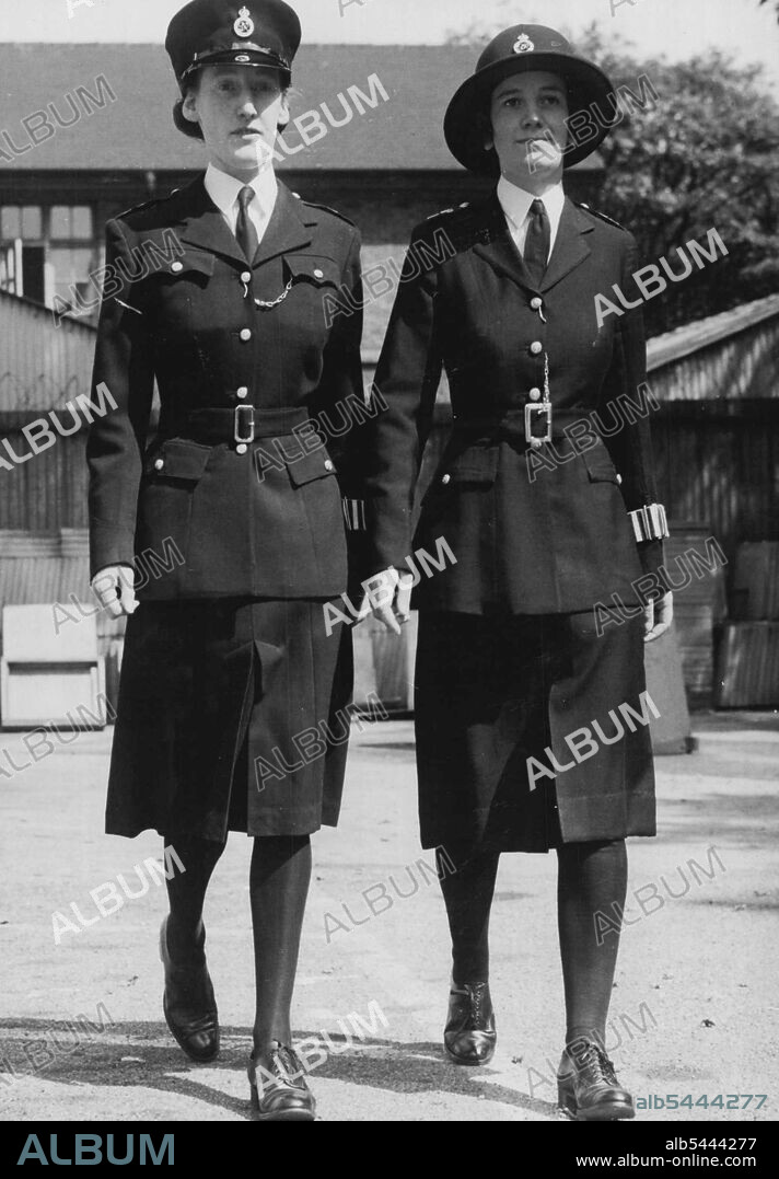 Modelling New Uniform For Policewomen The two uniforms at New Scotland Yard, London (left today July 23. The new outfit is on ***** and the present type on right. A new style uniform for policewomen will be issued sometime in November. This uniform has been designed to serve both in winter and summer, where as policewomen have been issued with summer and winter uniforms up to the present. It is made of Barathea and the tunic is improved in cut and design, with padded shoulders and two top patch pockets. A new six-pleat skirt has been designed so that it will hang better. July 23, 1946. (Photo by Associated Press Photo).