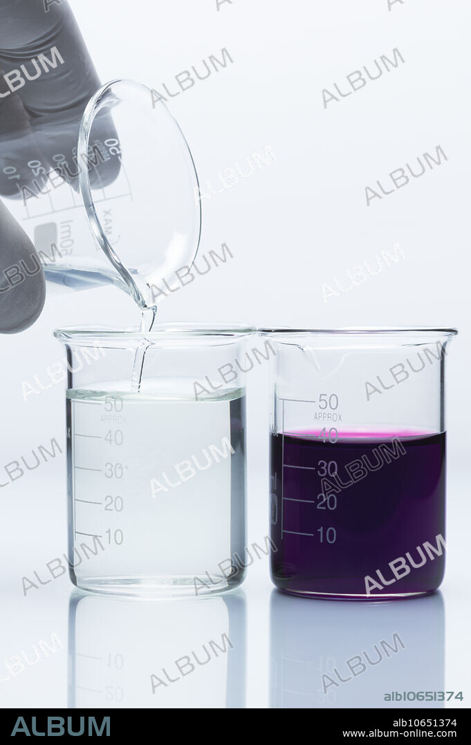 Reduction of potassium permanganate, 4 of 4. 0.2M solution of acidified iron(II) sulphate (FeSO4) is added to 0.001M solution of potassium permanganate (KMnO4). Purple permanganate MnO4- is reduced to colorless Mn2+ ion, while Fe2+ ion is oxidized to Fe3+: MnO4- + H+ + Fe2+ -> Mn2+ + H20 + Fe3+. A second beaker with potassium permanganate solution is included on the right for colour reference.