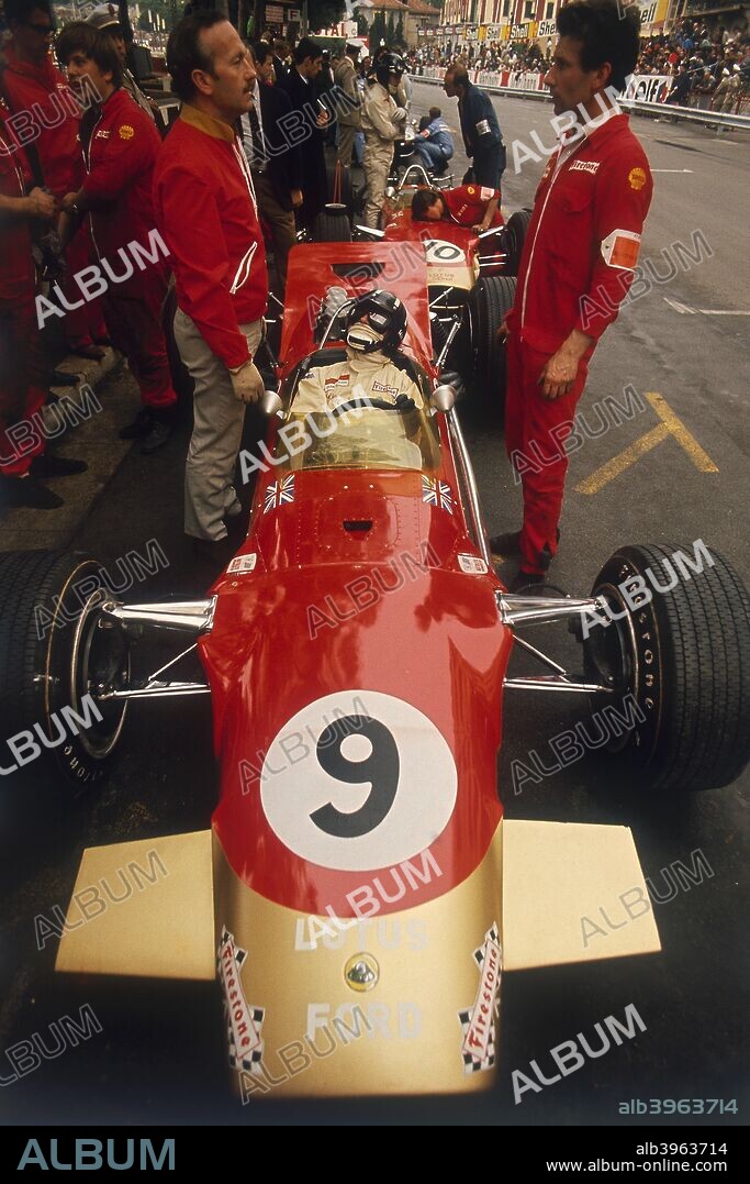 Colin Chapman and a mechanic in discussion over Graham Hill's Lotus, Monaco Grand Prix, 1969. Hill, World Champion in 1962 and 1968, drove the Lotus 49Bto victory in the race, his 5th win at Monaco. Chapman was the founder of Lotus Engineering Co, which built both road, Formula 1 and other competition sports cars. The Lotus team won seven Formula 1 Constructors' and six Drivers' World Championships between 1963 and 1978.