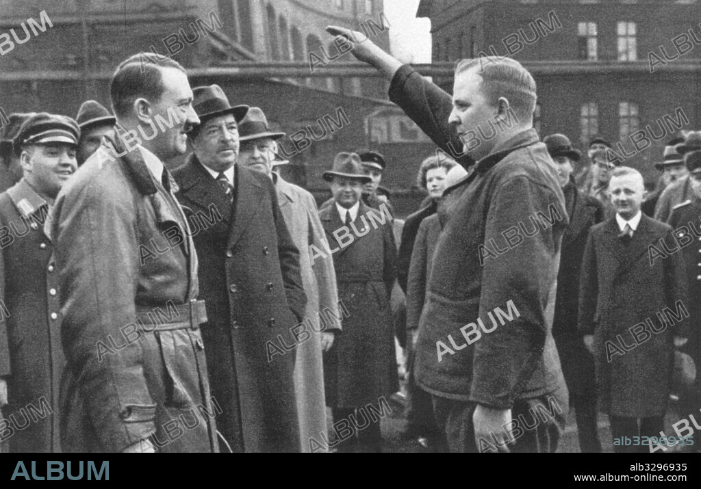 Adolf Hitler greeting workers' representative during a factory visit - 1934.