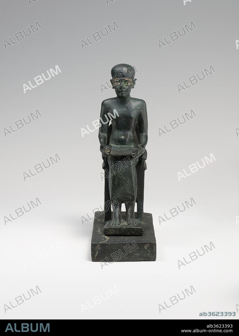 Statue of Seated Imhotep. Dimensions: H. 14 cm (5 1/2 in.); W. 4.8 cm (1 7/8 in.); D. 9.8 cm (3 7/8 in.). Date: 332-30 B.C..
Imhotep was the official who oversaw construction of Egypt's first monumental stone pyramid, at the beginning of the Third Dynasty (ca. 2650-2600 B.C.). The significance of this accomplishment made such an impression on the Egyptians that Imhotep was remembered and honored in later Egyptian history. Beginning in the New Kingdom he was invoked as the patron of writing and wisdom, and by the time this statue was made he had achieved fully divine status, with his own mythology and cult. Imhotep was also invoked for his intercession in sickness and infertility, and he was later equated by the Greeks with their own god of medicine, Asklepios.
Imhotep is almost always depicted with short-cropped hair or a cap, seated and holding an open papyrus scroll. In this example the finely inlaid figure of the god is made separately from his elaborate chair and base. The chair is tall with a rounded back, its seat surrounded by an elaborate cavetto-like molding, and the legs below the seat joined by panels with vertical cutouts.