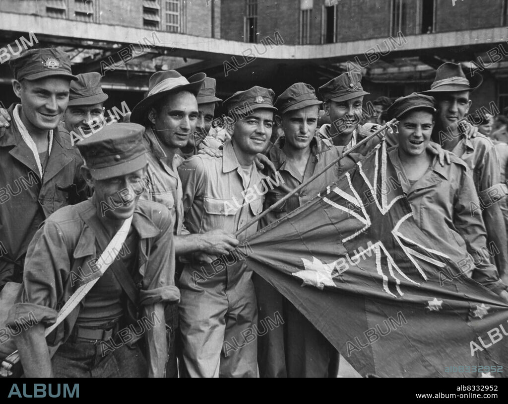 Released prisoners-of-war arrive at Yokohama railway station (Left to right) Pte. George Carroll of Towyong, Victoria, Pte. Jim Kay of Bega N.S.W. Cpl. Frank Lawrence of Nowra N.S.W, Pte. Jack White of Jerilderie N.S.W. Pte. Doug Mayers of South Melbourne, Pte. Harold Ramsey of Clayton Melbourne, Pte John Dwyer of South Brisbane, Pte. Walter Williams of Northbridge Sydney, Pte. Bill Mayne of Richmond Melbourne and Driver Arthur Hunt of Dorrigo. September 4, 1945. (Photo by Australian Official Photo).