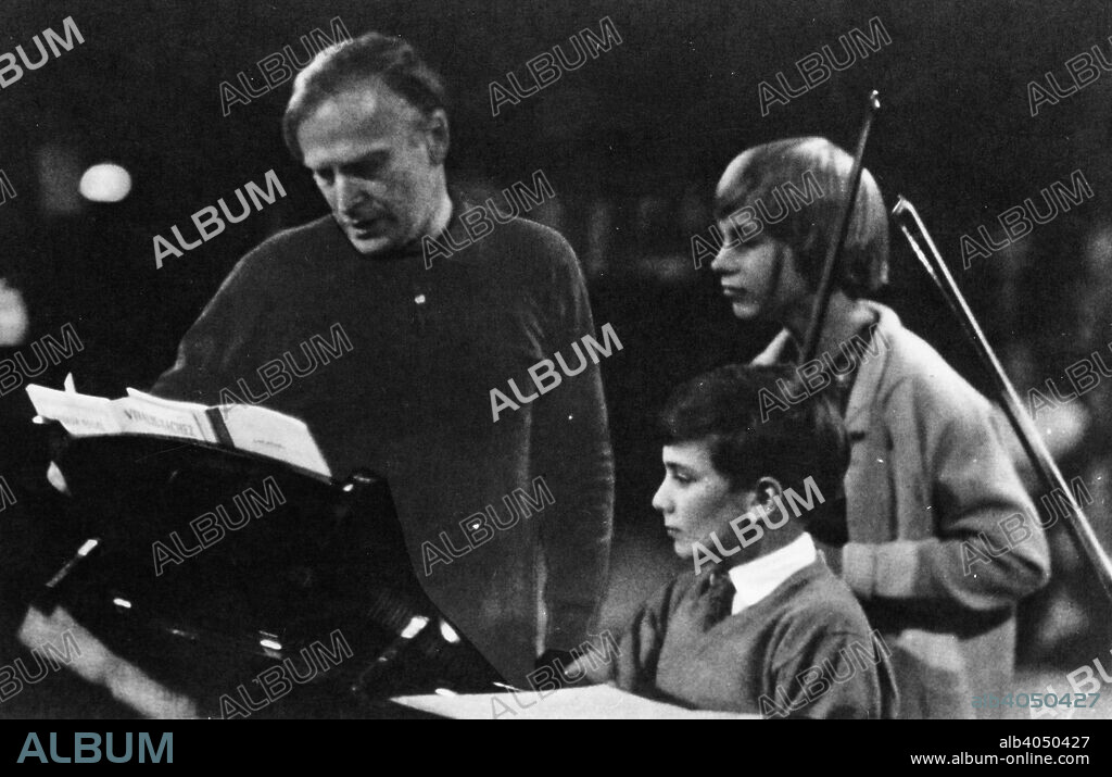 American musician Yehudi Menuhin (1916-1999) instructing his son Jeremy.