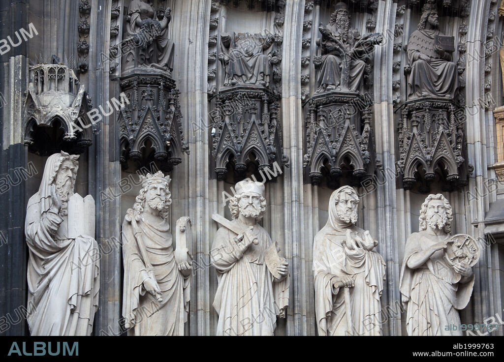 Germany, Cologne, Cologne Cathedral, West Facade, Portal of Mary, Jamb Sculptures . Cologne Cathedral was built was built to house the relics of the Three Magi, under the direction of Archbishop Conrad von Hochstaden. Construction of the present Gothic church began in August 15th, 1248 and completed in 1880. In 1996, the cathedral was added to the UNESCO world heritage list of culturally important sites. Seen are jambs sculptures of figures located in the left side of the west facade's main portal from the period of salvation, depicting from left to right: Moses, King David, Elijah, Joachim and John the Baptist.