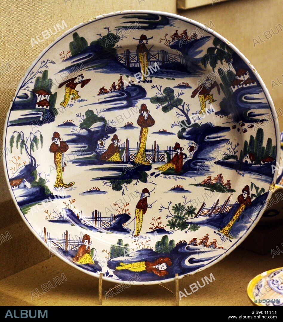 The 'Niglett' Dish, Bristol, dated 1733. This piece is the basis for much early chinoiserie decoration on delftware being ascribed to John Niglett, since the initials have been assumed to be those of Niglett and his wife Esther. John Niglett was apprenticed to Thomas Dixon of the Brislington Pottery in 1714.