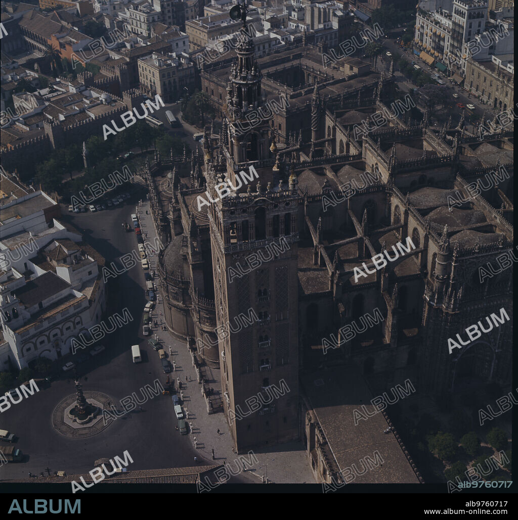 Seville, 1965 (CA.) . Aerial view of the city of Seville, with the Cathedral, the Giralda, and the Plaza Virgen de los Reyes.