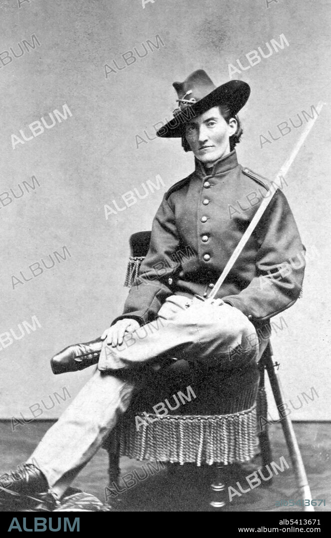 Entitled: "Frances L. Clayton, 4th Missouri Artillery, wounded in the battles of Shiloh and Stone River." Frances Louisa Clayton (1830s - after 1865), also recorded as Frances Clalin, was an American woman who disguised herself as a man to fight for the Union Army in the American Civil War. Under the alias Jack Williams, she enlisted in a Missouri regiment along with her husband, and fought in several battles. She left the army soon after her husband died at Stones River. Newspaper reports indicate that Clayton served in both cavalry and artillery units. Her story became known and widely circulated after her service, though each account contains contradictory information about her life and service. Several photographs of Clayton, including images of her in uniform, are known to exist. However, little else is known of her life. Unlike other women of the Civil War, Clayton was described by newspapers as tall and masculine-looking. She frequently took part in soldierly past-times such as drinking, smoking, or chewing tobacco. Photographed by Samuel Masury, 1865.