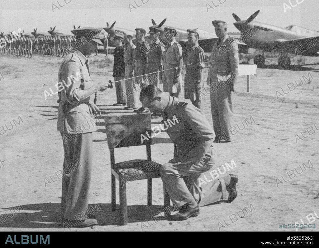 King Visits Victor Desert Air For E. Accolade Of Knighthood Conferred On Deputy A.O.C.-In-C -- The King seen conferring the Accolade of Knighthood upon Air Marshal Sir Francis Linnell.Returning from Malta to North Africa the King visited the 8th Army in Tripoli and the Battle H.Q. of General Montgomery. He also paid a visit to men of the Desert Air Forces who had made such a great contribution to tota1 victory in Africa.He conferred the Accolade of Knighthood on Air Marshal Sir Francis Linnell, Deputy A.0.G.-in-C. R.A.F.Middle East. This is the first time in history that such an investiture has taken place. September 18, 1943. (Photo by British Official Photograph).