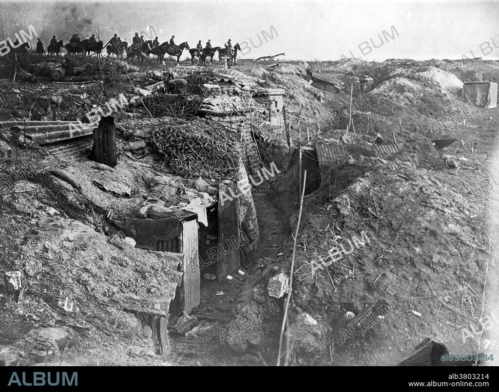 Abandoned British trench which was captured by the Germans; in background, German soldiers on horseback view the scene, circa 1914-18. No location given on caption card. Trench warfare is a form of land warfare using occupied fighting lines consisting largely of trenches, in which troops are significantly protected from the enemy's small arms fire and are substantially sheltered from artillery. The most prominent case of trench warfare is the Western Front in World War I. Both sides constructed elaborate trench and dugout systems opposing each other along a front, protected from assault by barbed wire. The area between opposing trench lines (no man's land) was fully exposed to artillery fire from both sides. Attacks, even if successful, often sustained severe casualties. The common infantry soldier had only a few weapons to use in the trenches: the rifle, bayonet, and hand grenade.
