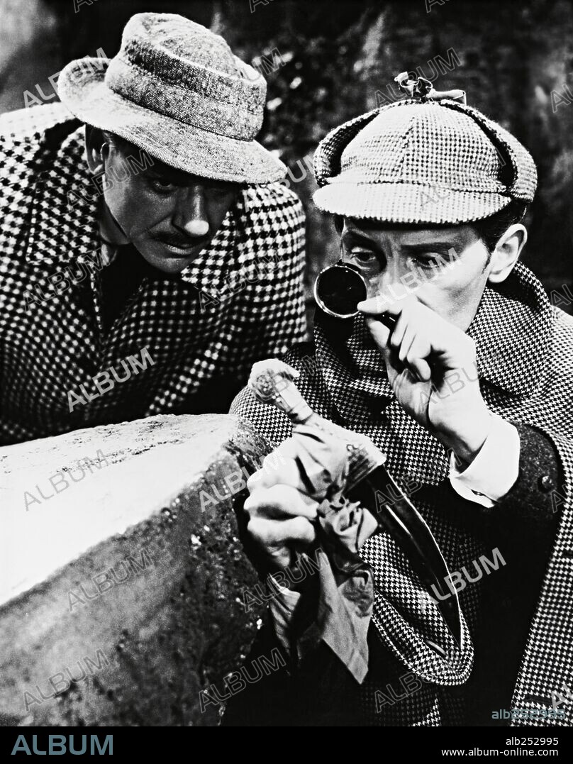 PETER CUSHING, ANDRE MORELL and JOHN WATSON. ANDRE MORELL and PETER CUSHING in THE HOUND OF THE BASKERVILLES, 1959, directed by TERENCE FISHER. Copyright HAMMER/UNITED ARTISTS.