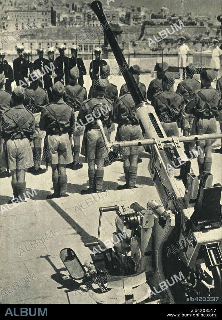 Royal Marines at the parade celebrating the successful defence of Malta, World War II, 1943 (1944). 'In Defence of Malta - The ceremonial parade on 20th May when, the duties completed, the marines turned their guns over to the Royal Artillery'. From "The Royal Marines - The Admiralty Account of Their Achievement 1939-43". [His Majesty's Stationery Office, London, 1944].