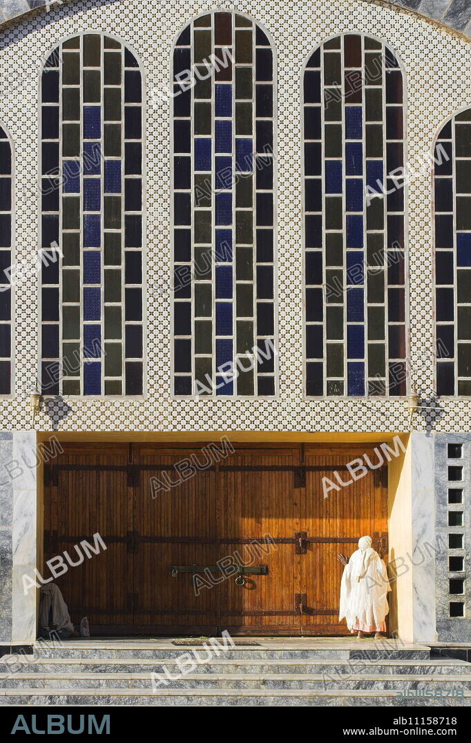 Pilgrim at doors of St. Mary of Zion new church, built by Haile Selassie in the 1960s, Axum, Ethiopia, Africa.