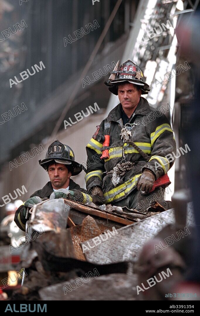 Two firefighters move debris in the site of the World Trade Center destruction site in New York City, New York, September 14, 2001. Image courtesy National Archives.