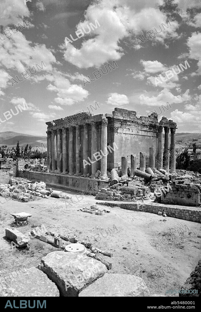 The Temple of Bacchus was one of the three main temples at a large complex in Classical Antiquity, at Baalbek in Lebanon. The temple was dedicated to Bacchus (also known as Dionysus), the Roman god of wine, but was traditionally referred to by Neoclassical visitors as the 'Temple of the Sun'. It is considered one of the best preserved Roman temples in the world. It is larger than the Parthenon in Greece, though much less famous. The temple was commissioned by Roman Emperor Antoninus Pius and designed by an unknown architect c. 150 AD, and built close to the courtyard in front of the larger temple of Jupiter-Baal. When the temple complex fell into disrepair, the Temple of Bacchus was protected by the rubble of the rest of the site's ruins. The temple is 66m long, 35m wide, and 31m high. Its walls are adorned by forty-two unfluted Corinthian columns, nineteen of which remain upright in position standing 19 m high. The columns support a richly carved entablature. Inside, the cella is decorated with Corinthian half-columns flanking two levels of niches on each side, containing scenes from the birth and life of Bacchus. The adyton (inner shrine) stands above a flight of steps.