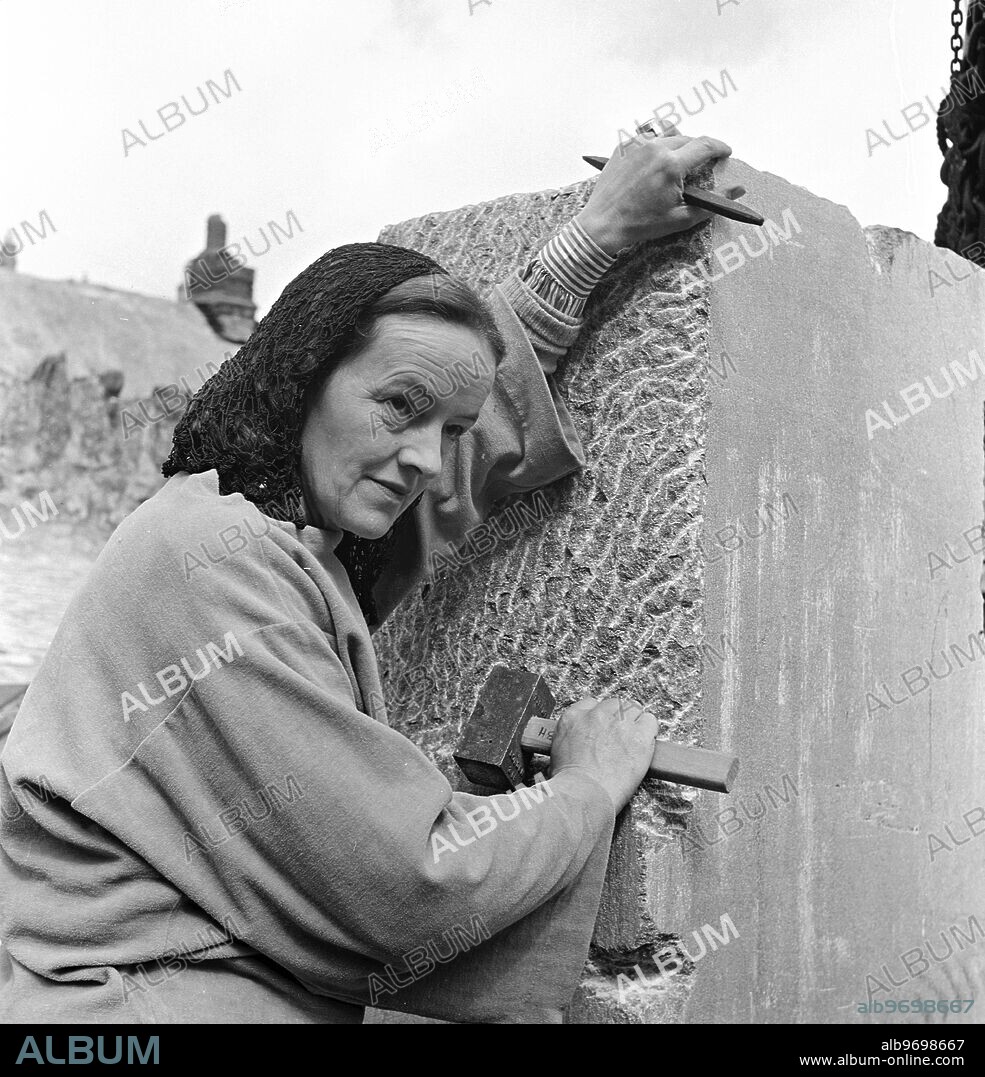 Barbara Hepworth photographed by Peter Keen of Pictorial Press in 1950. Artist and sculptor Barbara Hepworth outside working on a sculpture, for the Festival of Britain - Contrapuntal Forms (1951) made from Irish blue limestone. 1950 Barbara Hepworth - her studio and garden. She purchased the site in 1949 and lived and worked there for 26 years until her death in a fire on the premises in 1975. Barnoon Hill, St Ives.
