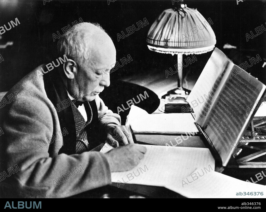 German Composer Richard Strauss(1864-1949), seated, working on a music manuscript. Known for his operas:: Salome, elektra and Der Rosenkavalier.