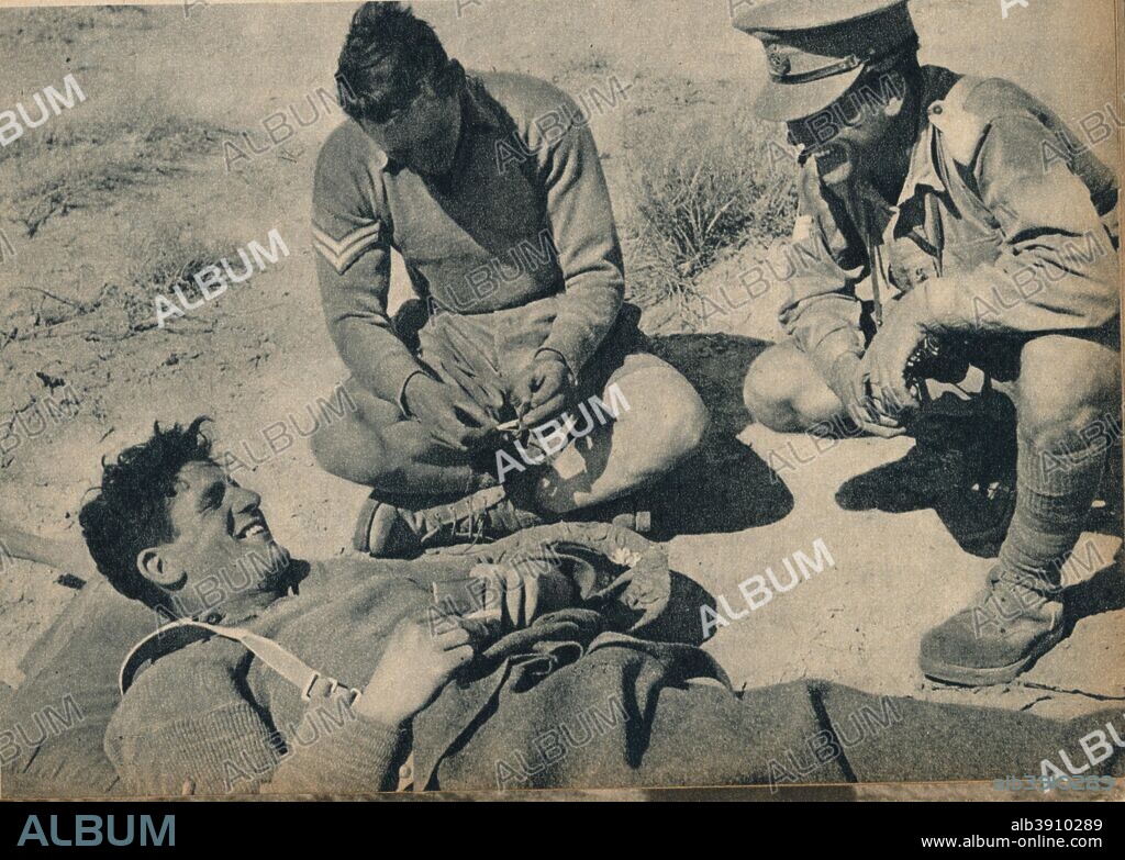 'Ambulance men with a wounded anti-tank gunner', c1942 (1944). A wounded soldier of the British Eighth Army in the North African desert. From The Eighth Army. [His Majesty's Stationery Office, London, 1944].