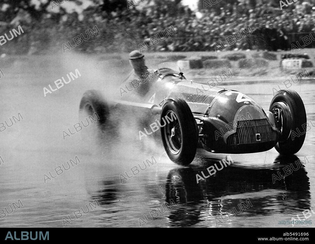 UNKNOWN. Argentinian racing driver Juan Manuel Fangio driving a 1950 Alfa Romeo 158 in the International Trophy at Silverstone.