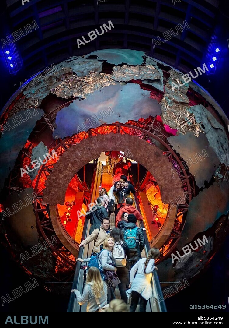 Escalator leading into a red ball, exhibition at the Natural History Museum, London, England, United Kingdom, Europe.