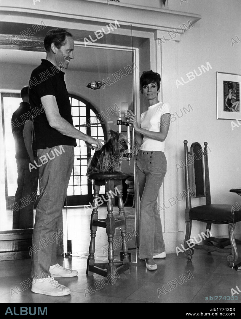 Audrey Hepburn with her husband Mel Ferrer. British actress Audrey Hepburn with her husband Mel Ferrer standing on the set of 'Two for the Road'. August 1966.