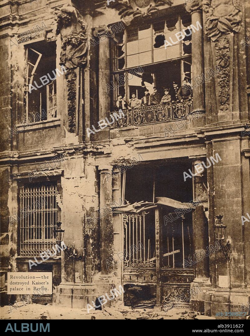 Members of the People's Marine Division on the Balcony of the City Palace, December 1918, 1918, (1938). The Berlin City Palace the royal and imperial palace in the centre of Berlin. Built in the 15th century and finalised by the middle 18th century, is attributed to German architect Andreas Schlüter (1664-1714). Following the defeat and forced abdication of William II (1859-1941) both as German Emperor and as King of Prussia the palace was sacked. In November 1918, the Spartacist leader, Karl Liebknecht (1871-1919), declared the German Socialist Republic from a balcony of the Palace, ending more than 400 years of royal occupation of the building. From These Tremendous Years 1919-1938. [Daily Express, London, 1938].