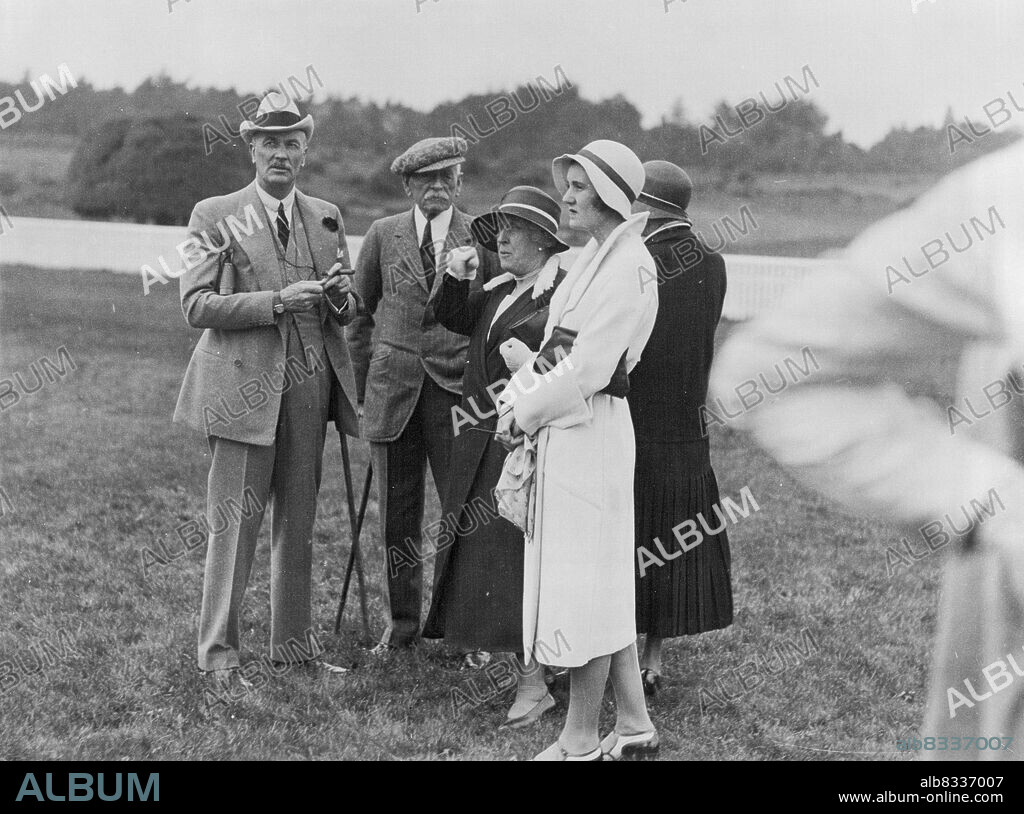 Princess Helena Victoria is a cousin of King George. Princess Helena Victoria (centre) and Col. Sir Gordon Carter (in cap), clerk of the course, watching scene on Ascot racecourse being filmed for Mr. Edgar Wallace's "The Calendar" by the British Lion Film Co. September 22, 1931.