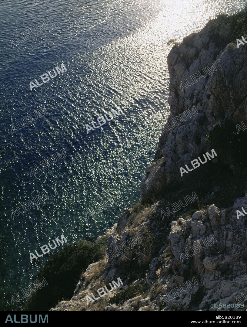 Moulourian Rock between Athens and Corinth, Greece. From this rock Ino, wife of Athamas, jumped into the sea with her son Melikertes, who was saved by a dolphin. Ino was transformed into the sea-goddess Leukothea. (Euripides, " Ino") .