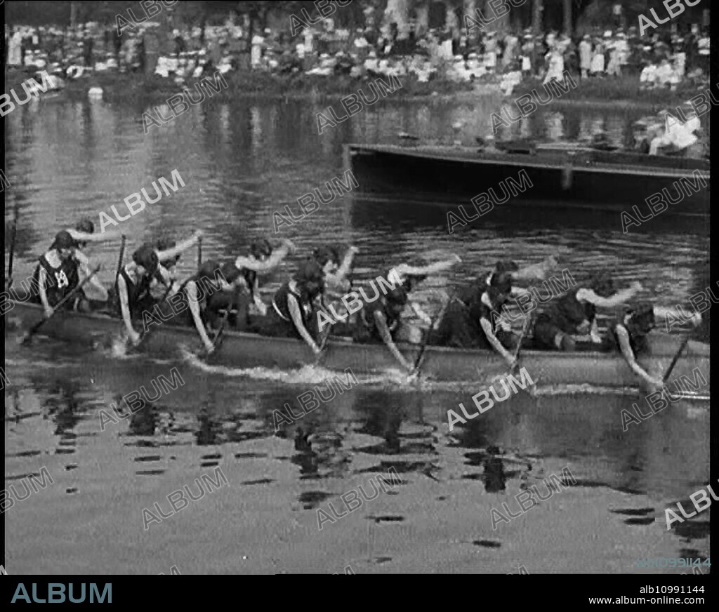 Young Female Civilians Wearing a Team Sport Outfit in a Rowing Race, an Audience Is Seen on the Margins of the River, 1920s. From "Time to Remember - Teenage Flapper", 1920s (Reel 2); a dcumentary about women's lives in the 1920s - great commentary by Joyce Grenfell.