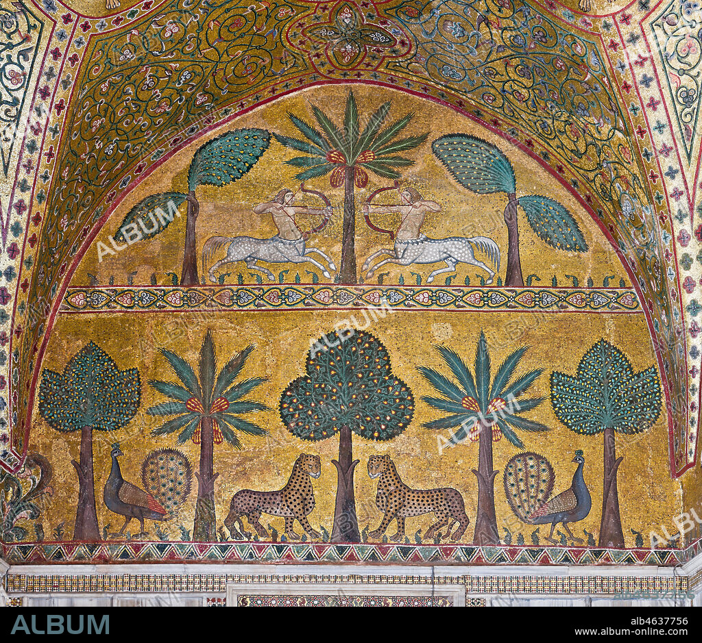 Palermo, The Royal Palace or Palazzo dei Normanni (Palace of the Normans), Pisana Tower, the King Roger Room: view of the Room which was commissioned by King Roger II d'Altavilla. It is characterized by large mosaic surfaces of great value representing plant elements and scenes of courtly and hunting style, symbols of the Norman power (hunting scenes with archers and deer, peacocks, swans, and mythological centaurs, griffins and other exotic animals among luxuriant vegetation). Mosaics are characterised by Greek Byzantine style (XIII century).. Detail with centaurs, peacocks, leopards and palm and banana trees.