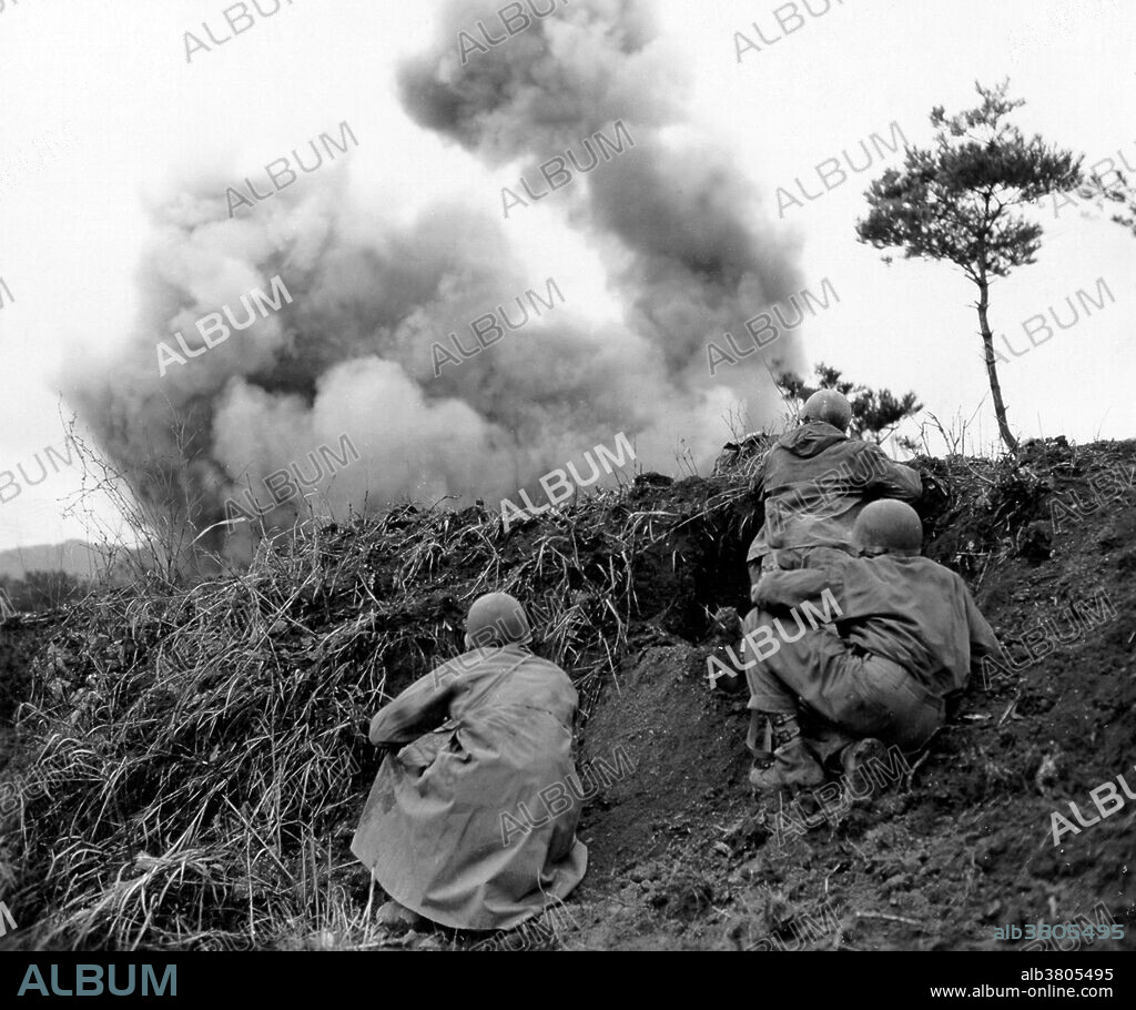 Caption: "Men of the 77th Engineer Combat Company blast at Communist troops taking cover in caves imbedded along steep banks of the Hantan River. April 11, 1951." On June 25, 1950, the Korean War began when soldiers from the North Korean People's Army crossed the 38th parallel, the boundary between the Soviet-backed Democratic People's Republic of Korea to the north and the pro-Western Republic of Korea to the south. This invasion was the first military action of the Cold War. By July, American troops had entered the war on South Korea's behalf. After some early back-and-forth across the 38th parallel, the fighting stalled and casualties mounted with nothing to show for them. Meanwhile, American officials worked to fashion some sort of armistice with the North Koreans. The alternative, they feared, would be a wider war with Russia and China. In July 1953, the Korean War came to an end. 5 million soldiers and civilians lost their lives during the war. The Korean peninsula is still divided today.