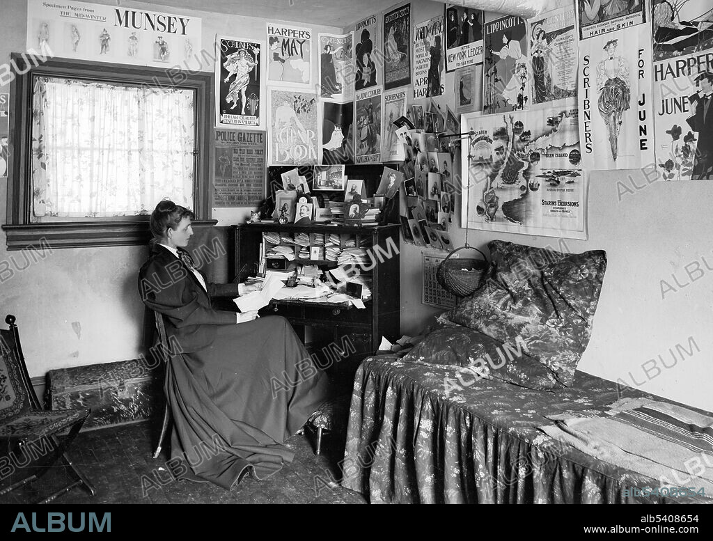 Johnston seated at a desk in her studio/office, with photographs and advertising posters on the walls, including the Chap Book, Harper's, and Lippincott's magazines. Frances "Fannie" Benjamin Johnston (January 15, 1864 - May 16, 1952) was an American photographer and photojournalist. She received training in photography from Thomas Smillie, director of photography at the Smithsonian. She took portraits of many famous contemporaries. In the 1920s, she became interested in photographing architecture, documenting buildings and gardens which were falling into disrepair or about to be redeveloped and lost. Her photographs remain an important resource for modern architects, historians and conservationists. July 1895.