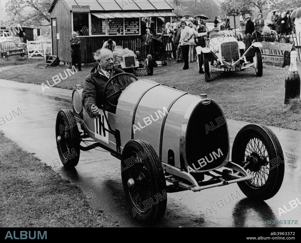 Raymond Mays in a Bugatti Brescia, 1970s. Taking part in the Prescott Hill Climb. Mays was a racing driver of the pre-war period, and played an important role in the creation of the ERA (English Racing Automobiles Ltd) and BRM (British Racing Motors) cars. He started racing in 1921 with a Hillman, specialising in hillclimbs and sprint events. He also raced Bugattis, ACs and Vauxhalls. With Victor Riley he built the 'White Riley' and with the sponsorship from Humphrey Cook the project developed into the ERA. Mays was co-founder and head driver of the team and the cars were built on his home yard at Bourne. In 1937 ERA and Mays dominated the Voiturette season. In 1939 Mays raced his ERA as an independent. After the war Mays continued to compete but gradually became engaged in promoting BRM. He retired from racing after the 1949 International Trophy.