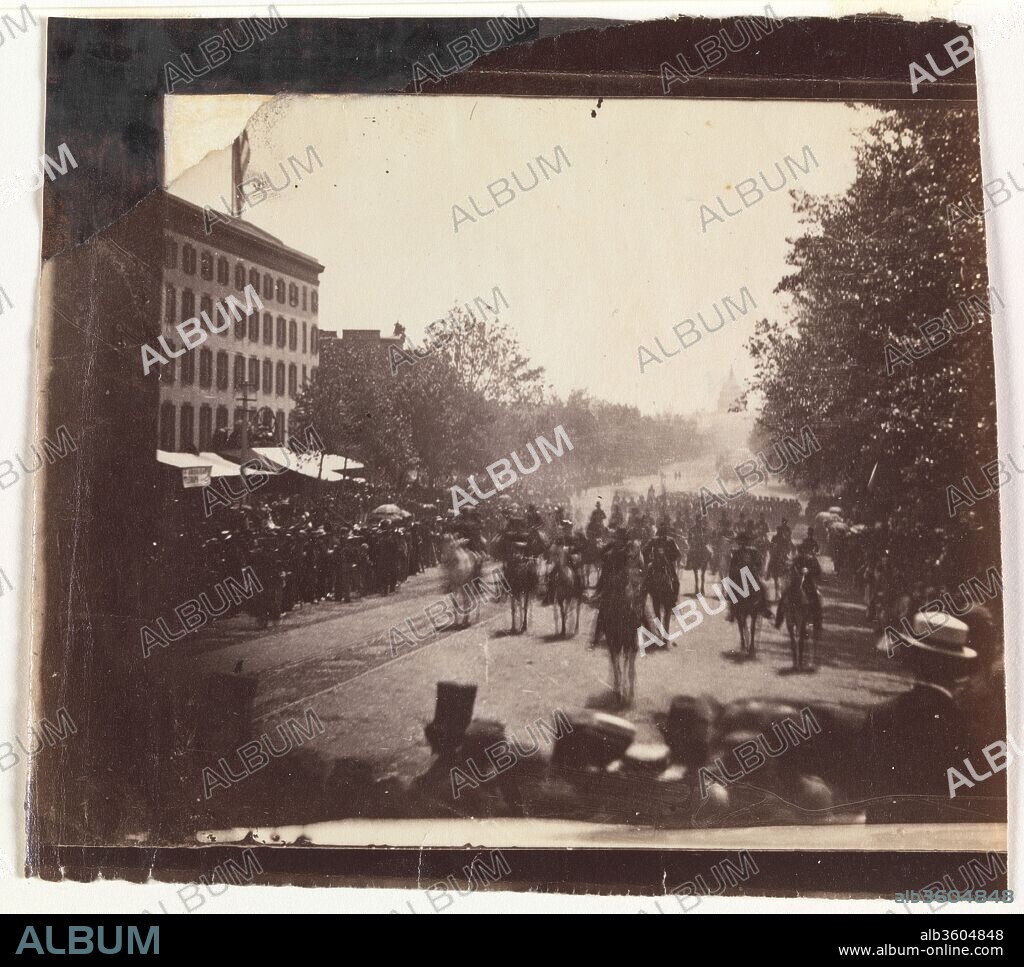 [Grand Army Review, Pennsylvania Avenue, Washington]. Artist: Alexander Gardner (American, Glasgow, Scotland 1821-1882 Washington, D.C.). Dimensions: 8.8 × 9.9 cm (3 7/16 × 3 7/8 in.), irregularly trimmed. Date: May 23 or 24, 1865.
On May 23 and 24, 1865, two weeks after the president of the Confederacy, Jefferson Davis, was taken prisoner in Georgia, more than 150,000 jubilant soldiers marched up Pennsylvania Avenue as part of the Grand Army Review. To the sounds of bands playing "When Johnny Comes Marching Home," the armies of the Potomac, Tennessee, and Georgia were feted in a victory parade to celebrate the end of the war. Traveling from the newly completed Capitol (seen in the distance) to the main reviewing stand in front of the Executive Mansion, row after row of men passed before Alexander Gardner's stereoscopic camera, positioned just above the heads of the crowd.
Posted opposite the Willard Hotel, today still standing at Pennsylvania Avenue and 14th Street, Gardner and several assistants worked to document the event with relatively fast, small plate cameras. The resulting views, in which the soldiers and horses are blurred, were taken from the spectators' level rather than from an ideal vantage point, thus anticipating by twenty years the contingent look of street photography made with hand-held cameras. Statistics would later reveal that four times the number of men who marched in the Grand Army Review had died in the war.