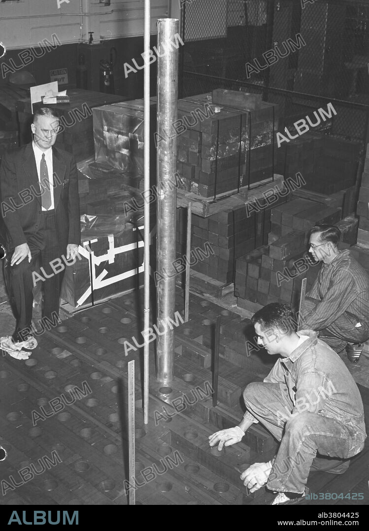 Walter Zinn at Chicago Pile-1. Chicago Pile-1 (CP-1) was the world's first man-made nuclear reactor. CP-1 consisted of 45,000 graphite bricks stacked in 587 layers. The first self-sustaining nuclear chain reaction was initiated in CP-1 on December 2, 1942 at its site underneath the University of Chicago's Stagg Field football stadium. The site is now a National Historic Landmark. Walter Zinn (1906-2000) was a Canadian-born nuclear physicist who worked on the Manhattan Project, was a director of the Argonne National Laboratory from 1946-1956, and developed and built several new reactor designs.