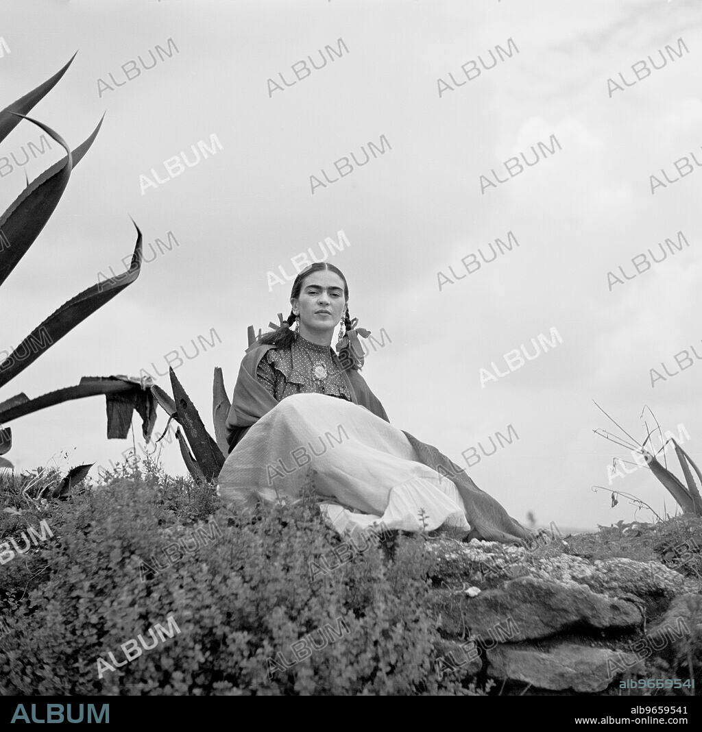 Frida Kahlo (Senora Diego Rivera) seated next to Agave Plant during Photo Shoot for Vogue Magazine, photograph by Toni Frissell, 1937.