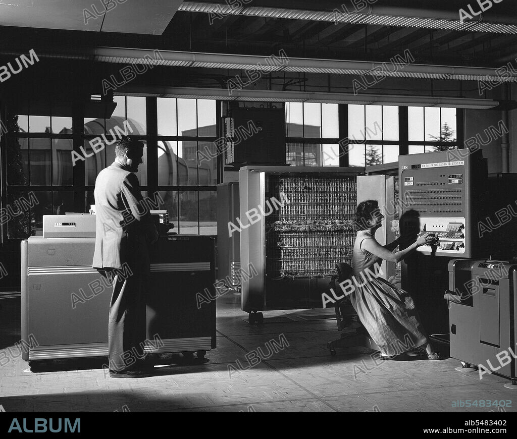 1958 - Electronic Machine Computing Branch, 704 computing lab; (left - right) William A Mersman and Marcelline K Chartz (aka - Marcie Smith) with IBM 704 Data Processor.