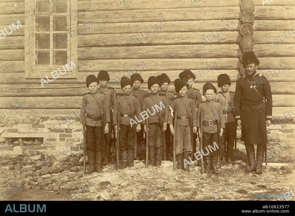 NIKOLAI GEORGIEVICH KATANAEV. Children's Formation, 1909. From Tipy postroek v stanitsakh Sibirskogo kazach'ego voiska (Types of construction in the villages of the Siberian Cossack Host), one of three albums depicting the territories, culture, and the way of life of the Cossacks living in the steppe regions of western Siberia and present-day Kazakhstan. These albums were created for and exhibited at the First West Siberian Agricultural, Forestry, and Commercial-Industrial Exhibition in Omsk in 1911. The albums were part of a collection of photographs assembled between 1891 and 1918 by the museum of the West Siberian Branch of the Imperial Russian Geographic Society in Omsk. The photographs in the albums were taken in 1909 by N. G. Katanaev (son of Colonel G. E. Katanaev) during a journey to Cossack settlements in Stepnoi krai (later the oblasts of Ural'sk, Turgai, Akmola, and Semipalatinsk). Omsk State Museum of Regional History and Folklife.
