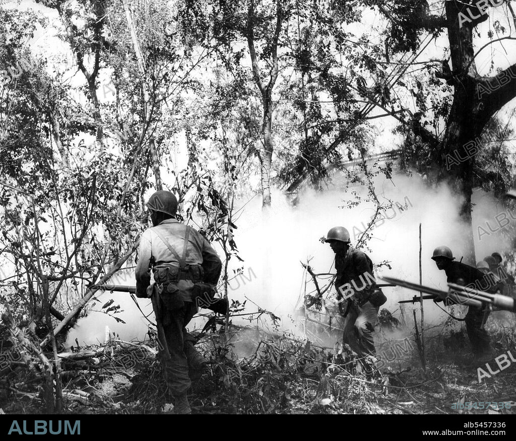 Yanks Advance In Smoke ScreenSoldiers of the 1st Infantry regiment, 6th Division, advance in the Cabaruan Hills, Luzon Island, after throwing several smoke grenades ahead. February 19, 1945. (Photo by USA Signal Corps).