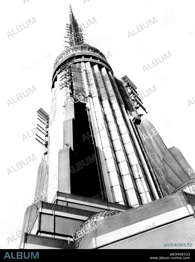The Empire State Building is a 10-story Art Deco skyscraper in Midtown Manhattan, NYC. The building has a roof height of 1,250 feet and stands a total of 1,454 feet tall, including its antenna. The Empire State Building stood as the world's tallest building for nearly 40 years. A symbol of NYC, the tower has been named as one of the Seven Wonders of the Modern World by the American Society of Civil Engineers. The Empire State Building and its ground-floor interior have been designated as a city landmark by the New York City Landmarks Preservation Commission, and designated a National Historic Landmark in 1986. Photographed by New York World-Telegram and the Sun Newspaper, 1954 (cropped and cleaned).