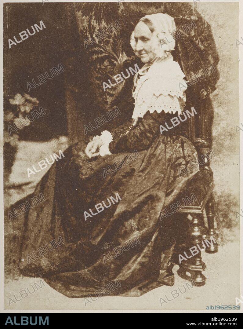Mrs. Rigby. Full-length seated portrait, looking off to the left, of Elizabeth Rigby (1809-1893), later Lady Eastlake. One Hundred Calotype Sketches by D. O. Hill, R.S.A. and R. Adamson. Edinburgh, 1848 [1859?]. From a volume of calotype images and portraits. Early photographic technique also called Talbotype. Dating from 1849. David Octavius Hill and Robert Adamson. Source: C.128.k.10 39.