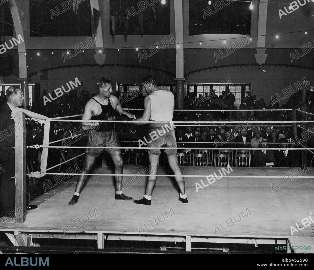 Phil Scott Getting Ready For Stribling - Phil Scott sparring with a Don Shortland in the Pier Pavilion at Herne Bay, in preparation for his fight with Young Stribling. Spectators attempt his practice the money going to charities. September 11, 1930. (Photo by Central Press Photograph).