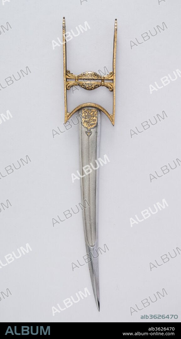 Dagger (Katar). Culture: South Indian, Mughal. Dimensions: H. 18 7/8 in. (47.9 cm); W. 3 7/16 in. (8.7 cm); Wt. 1 lb. 0.2 oz. (459.3 g). Date: 18th century.
The watered steel blade has a chiseled medallion at the top of both sides decorated with an inscription that reads: "Help from Allah and a speedy victory. So give the glad tidings to the believers" (Koran 61:13).