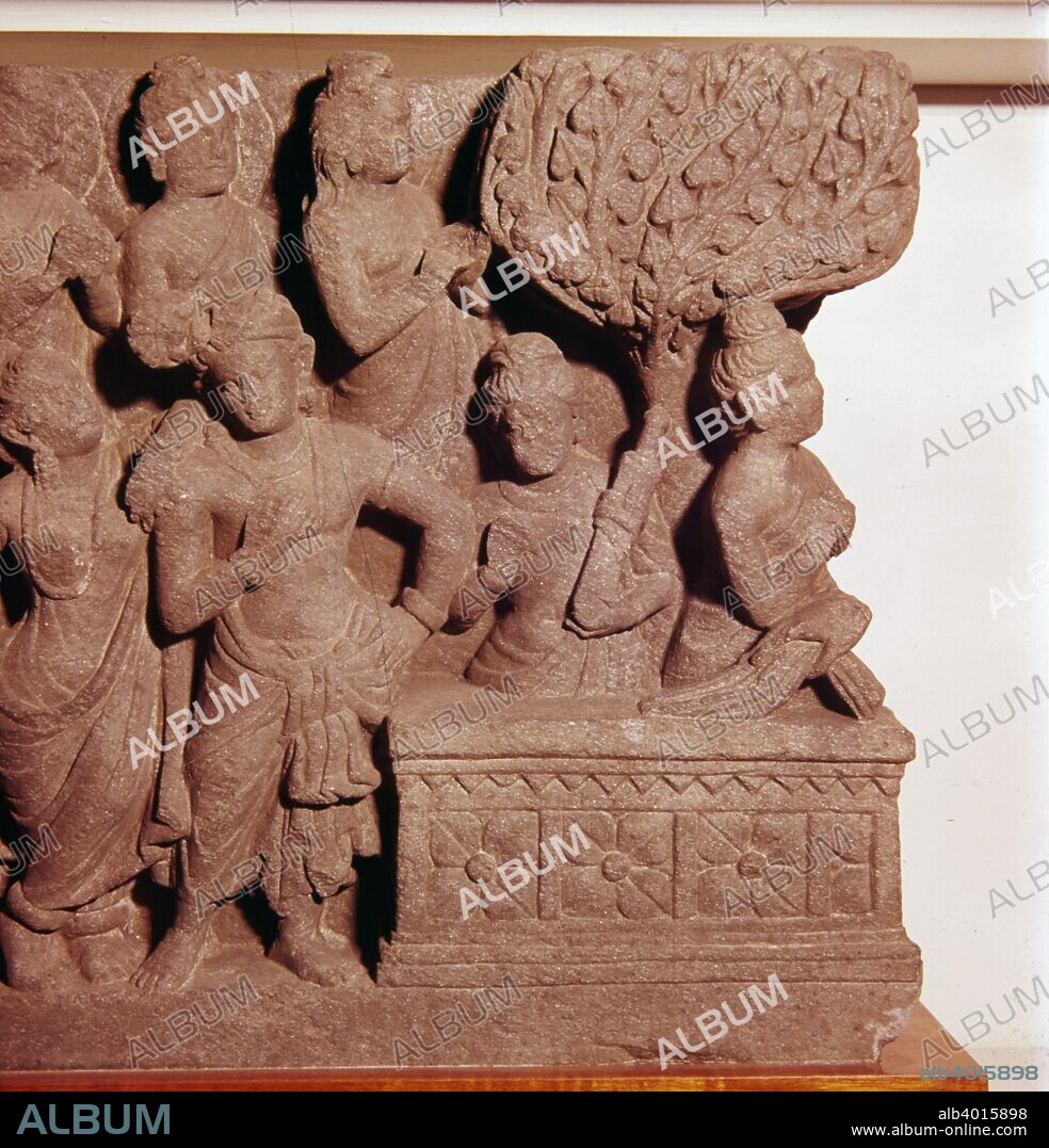 Panel from The Bodhimanda, Buddha prepares for enlightenment, c2nd-3rd century.  The Naga, Kalika, and his wife, comfort the Buddha as he takes his seat under the Bodhi-Tree. Relief carving. At British Museum.