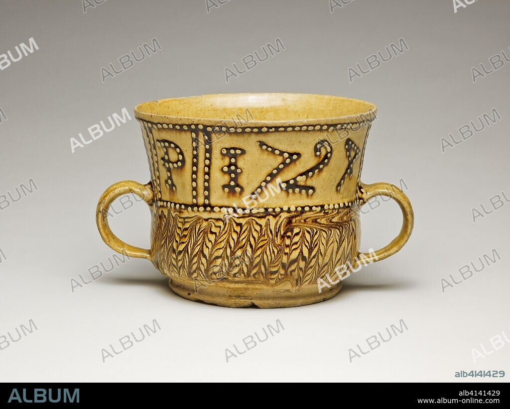 STAFFORDSHIRE POTTERIES. Cup. Staffordshire, England. Date: 1724. Dimensions: 21.8 × 12.9 cm (8 9/16 × 5 1/16 in.). Earthenware with slipware decoration. Origin: Staffordshire.