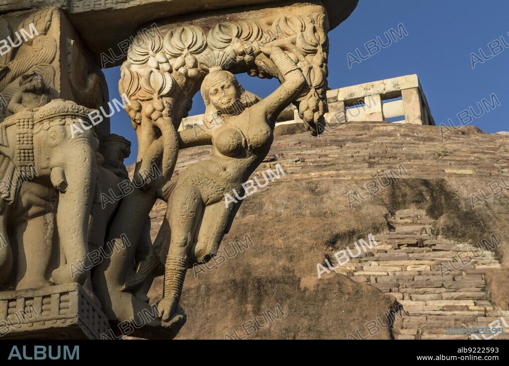 Yakshini (Yakshi) of the East Torana, gateway to the Great Stupa, Stupa 1, at Sanchi, some trees. The main monument in the group of Buddhist Monuments at Sanchi. UNESCO World Heritage Site. Sanchi, Madhya Pradesh, India, Asia.