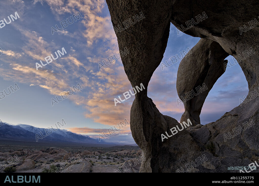 Sunset through Cyclops' Skull Arch, Alabama Hills, Inyo National Forest, California, United States of America, North America.